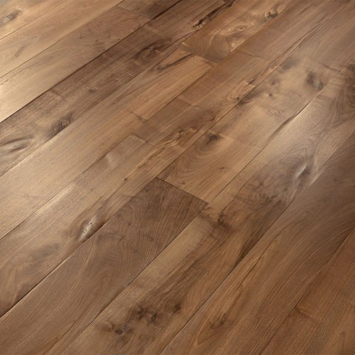 Engineered wood planks floor in European Walnut: brushed, aged effect, hand carved, varnished.