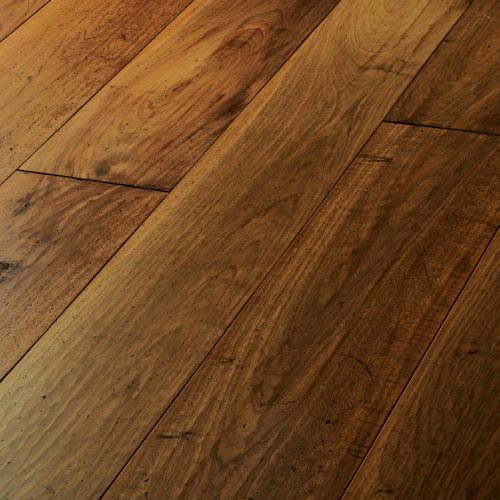 Engineered wood planks floor in European Walnut: hand planed, aged, stained, oiled and waxed.