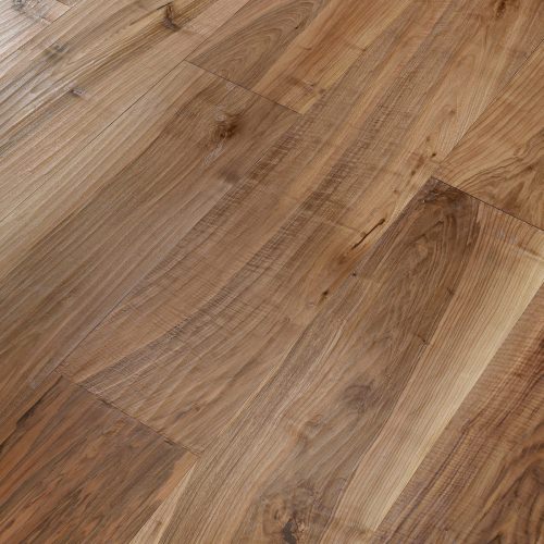 Engineered wood planks floor in European Walnut: hand planed, varnished.