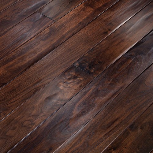 Engineered wood planks floor in American Walnut: aged effect, hand carved, stained, varnished, rounded bevels.