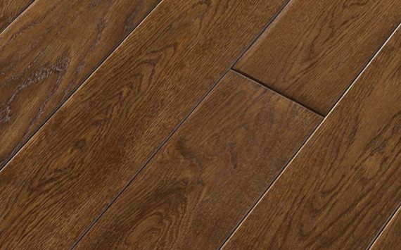 Engineered wood planks floor in Oak: smoked, rounded bevels, hand carved, stained, varnished.