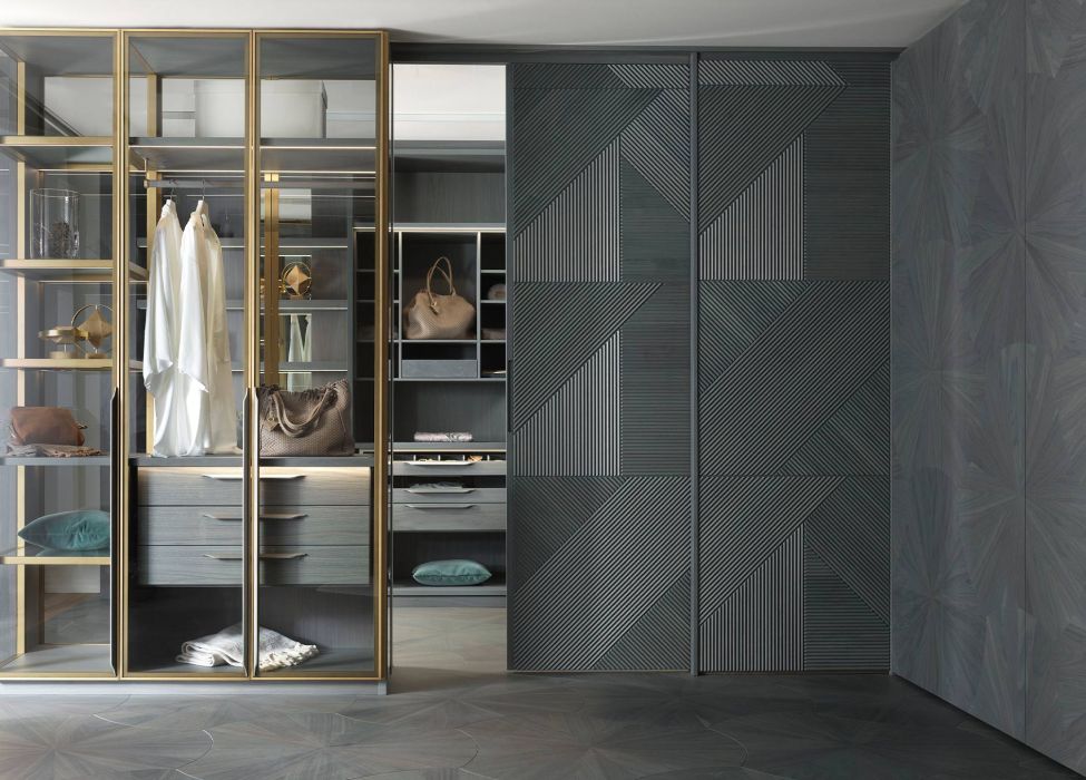 Walk-in wardrobe with an open sliding door clad in Tribeca 3D panelling in a Colorsense Sky Blue finish, integrated into a continuous geometric composition.